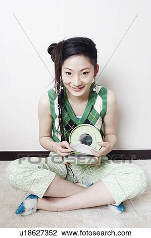 Portrait of a teenage girl holding a CD case View Large Photo Image Stock Image - Portrait of a teenage girl holding a CD case. Fotosearch