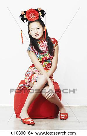 Picture - Portrait of a teenage girl sitting on a stool. Fotosearch