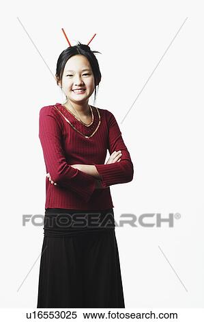 Portrait of a teenage girl smiling with her arms crossed View Large Photo Image Stock Photography - Portrait of a teenage girl smiling with her arms crossed. Fotosearch