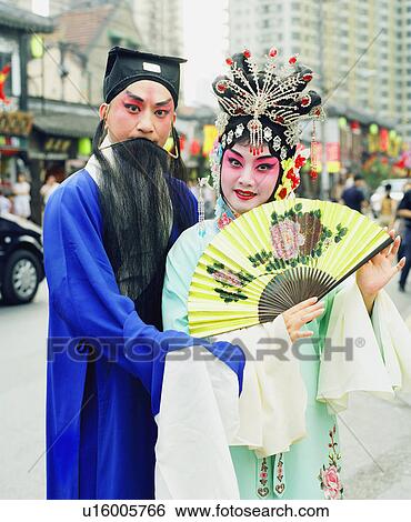 Stock Photograph - Portrait of a young couple standing together. Fotosearch