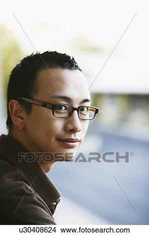 Picture - Portrait of a young man grinning. Fotosearch