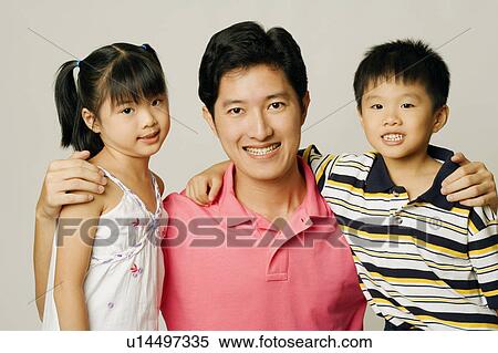 Stock Photography - Portrait of a young man with his son and daughter. Fotosearch