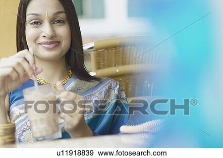 Portrait of a young woman drinking a milkshake View Large Photo Image Stock Photo - Portrait of a young woman drinking a milkshake. Fotosearch