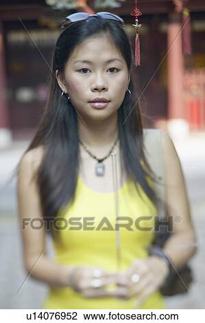 Portrait of a young woman holding an incense stick View Large Photo Image Stock Image - Portrait of a young woman holding an incense stick. Fotosearch