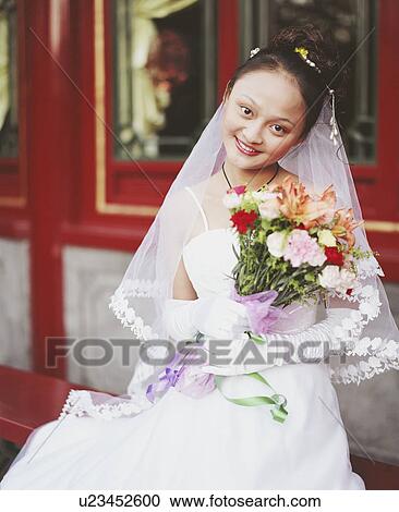 Stock Image - Portrait of a young woman in the wedding dress . Fotosearch