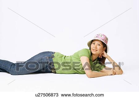 Portrait of a young woman lying on her side View Large Photo Image Stock Image - Portrait of a young woman lying on her side. Fotosearch