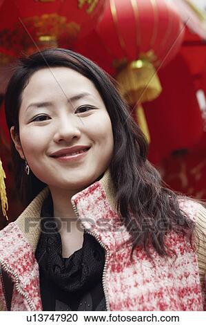 Stock Image - Portrait of a young woman smiling. Fotosearch