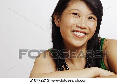 Stock Image - Portrait of a young woman smiling. Fotosearch