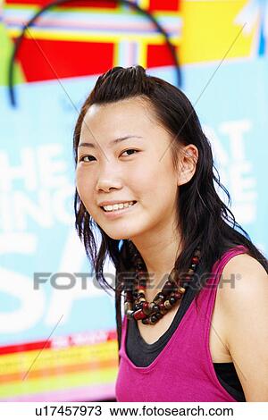 Stock Image - Portrait of a young woman smiling. Fotosearch