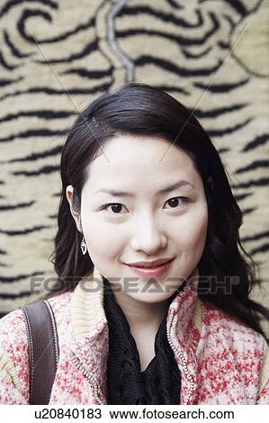 Portrait of a young woman smiling View Large Photo Image Stock Image - Portrait of a young woman smiling. Fotosearch