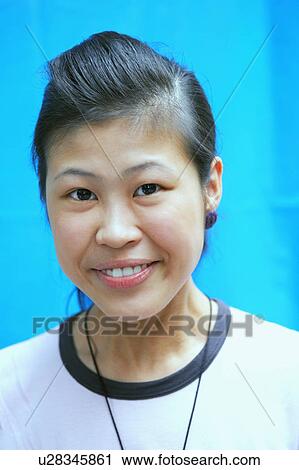 Portrait of a young woman smiling View Large Photo Image Stock Image - Portrait of a young woman smiling. Fotosearch