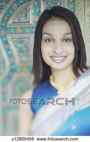Portrait of a young woman smiling View Large Photo Image Stock Photo - Portrait of a young woman smiling. Fotosearch