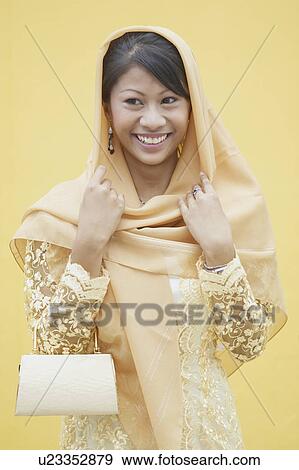 Portrait of a young woman smiling View Large Photo Image Stock Photo - Portrait of a young woman smiling. Fotosearch