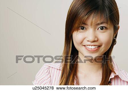 Portrait of a young woman smiling View Large Photo Image Stock Photo - Portrait of a young woman smiling. Fotosearch