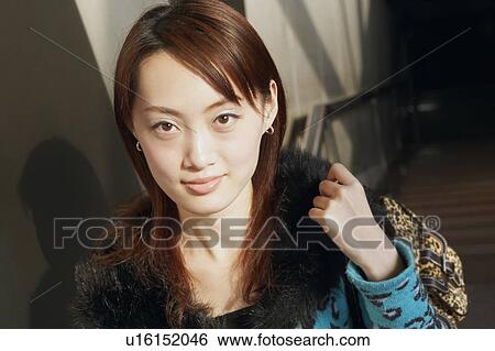 Portrait of a young woman smiling View Large Photo Image Stock Photograph - Portrait of a young woman smiling. Fotosearch