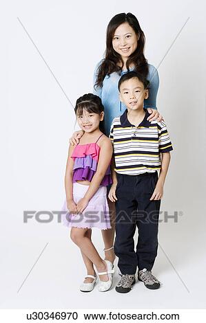 Portrait of a young woman standing with her son and daughter View Large Photo Image Stock Image - Portrait of a young woman standing with her son and daughter. Fotosearch