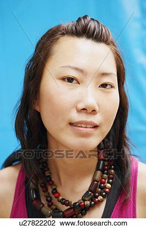 Portrait of a young woman wearing a necklace View Large Photo Image Stock Image - Portrait of a young woman wearing a necklace. Fotosearch