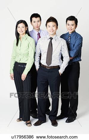 Stock Photograph - Portrait of three businessmen and one businesswoman standing. Fotosearch