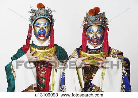 Portrait of two male Chinese opera performers holding bowls full of gold coins View Large Photo Image Stock Image - Portrait of two male Chinese opera performers holding bowls full of gold coins. Fotosearch