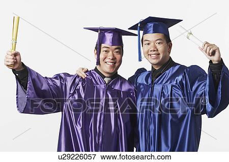Stock Photo - Portrait of two male graduates holding diplomas. Fotosearch