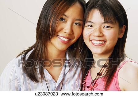 Portrait of two young women smiling View Large Photo Image Stock Image - Portrait of two young women smiling. Fotosearch