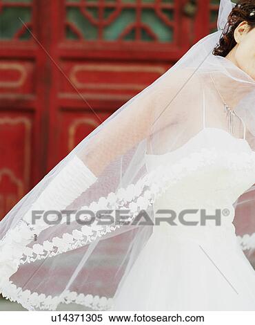Stock Photography - Side profile of a young woman in the wedding dress. Fotosearch