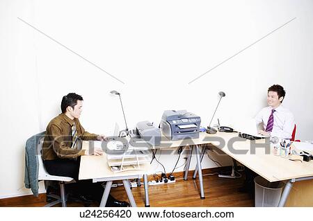 Two businessmen sitting face to face View Large Photo Image Stock Image - Two businessmen sitting face to face. Fotosearch