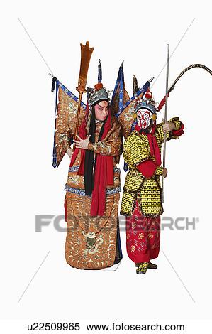 Stock Photography - Two male Chinese opera performers gesturing with weapons. Fotosearch