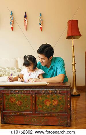 Young man teaching his daughter to color View Large Photo Image Stock Image - Young man teaching his daughter to color. Fotosearch