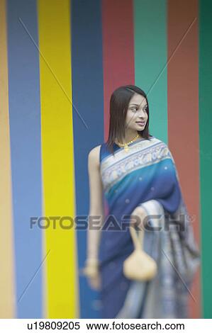 Stock Photography - Young woman holding a purse. Fotosearch