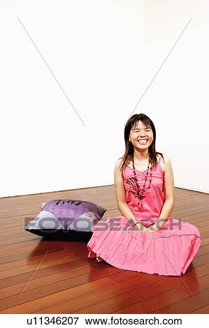 Young woman looking cheerful with her eyes closed View Large Photo Image Stock Photo - Young woman looking cheerful with her eyes closed. Fotosearch