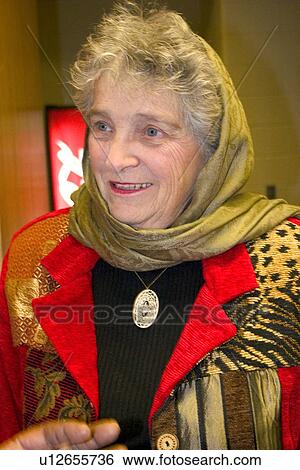 Stock Photograph - Active senior volunteer attending a Christmas party. Fotosearch