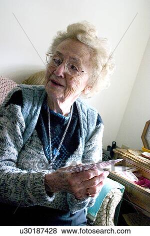 Aunt Fran age 92 playing with large print cards Edina Minnesota USA View Large Photo Image Stock Photo - Aunt Fran age 92 playing with large print cards Edina Minnesota USA. Fotosearch