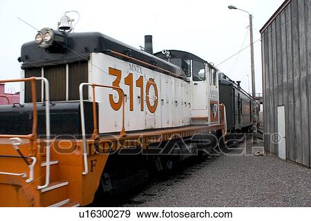 Stock Photo - Engine pulling rail cars with patrons and passengers riding and enjoying a benefit train trip on the Osceola and St. Croix Valle. Fotosearch