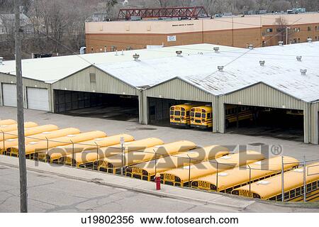 Stock Photograph - Line up of orange school buses in the motor pool. Fotosearch