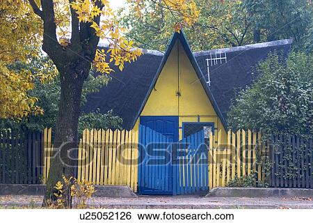 Quaint house in yellow and blue and tall picket fence View Large Photo Image Stock Photograph - Quaint house in yellow and blue and tall picket fence. Fotosearch