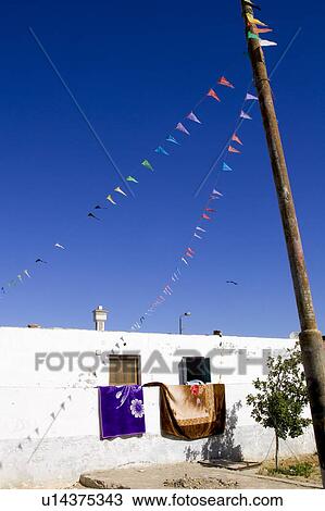 Stock Image - Building Exterior, Building Structure, Clear Sky, Clothesline, Day. Fotosearch