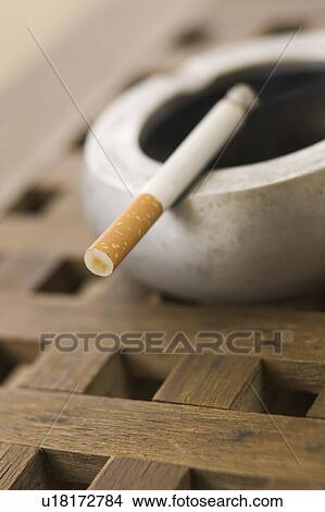 Picture - Burning, Social Issues, Tobacco Product, Cigarette, Ashtray. Fotosearch
