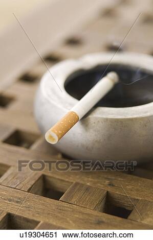 Stock Image - Burning, Social Issues, Tobacco Product, Cigarette, Ashtray. Fotosearch