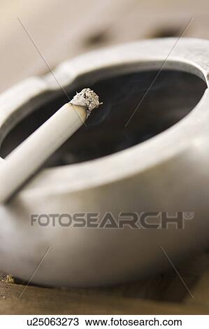 Stock Image - Circular, Burning, Social Issues, Tobacco Product, Cigarette, Ashtray. Fotosearch