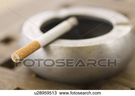 Stock Image - Circular, Burning, Social Issues, Tobacco Product, Cigarette, Ashtray. Fotosearch
