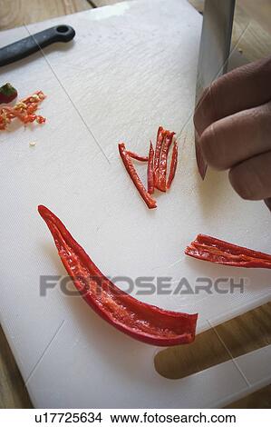 Close-Up, Cutting, Cutting Board, Food, Holding View Large Photo Image Picture - Close-Up, Cutting, Cutting Board, Food, Holding. Fotosearch