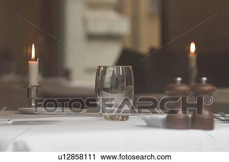 Stock Image - glass, table, candles, light, illumination, night. Fotosearch