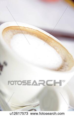 Stock Image - Cup of cappuccino with milk froth, close up. Fotosearch