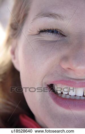 Stock Image - Portrait of young blond woman smiling, close up. Fotosearch