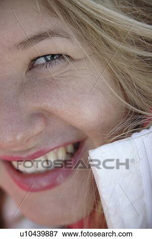 Portrait of young blond woman smiling, close up View Large Photo Image Stock Photo - Portrait of young blond woman smiling, close up. Fotosearch
