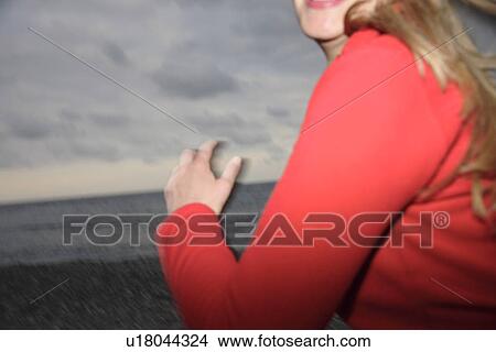 Upper part of woman's body jogging at the beach, side view View Large Photo Image Picture - Upper part of woman's body jogging at the beach, side view. Fotosearch