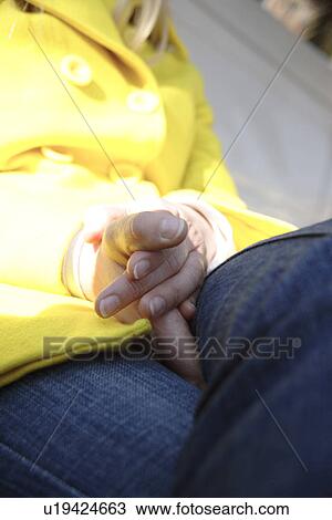 Woman in yellow rain coat sitting on bench, close-up View Large Photo Image Stock Image - Woman in yellow rain coat sitting on bench, close-up. Fotosearch