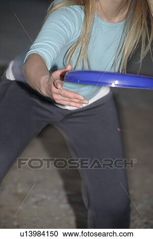 Woman playing with a frisbee, throwing and catching, in front of dark clouds View Large Photo Image Stock Image - Woman playing with a frisbee, throwing and catching, in front of dark clouds. Fotosearch