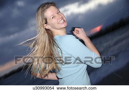 Young blond woman jogging at the beach, portrait View Large Photo Image Picture - Young blond woman jogging at the beach, portrait. Fotosearch